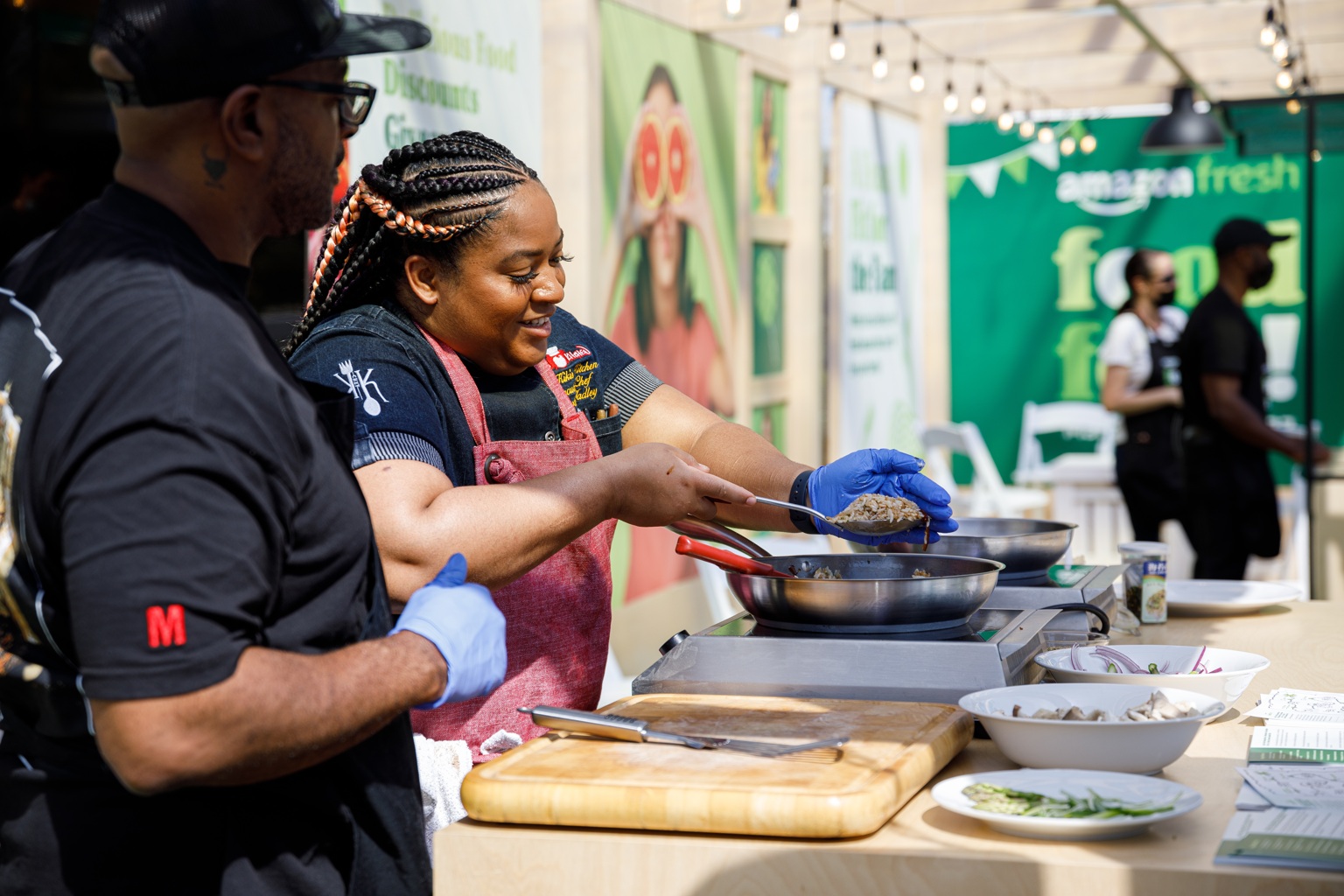 Chefs preparing food for visitors at an Amazon Fresh store launch.
